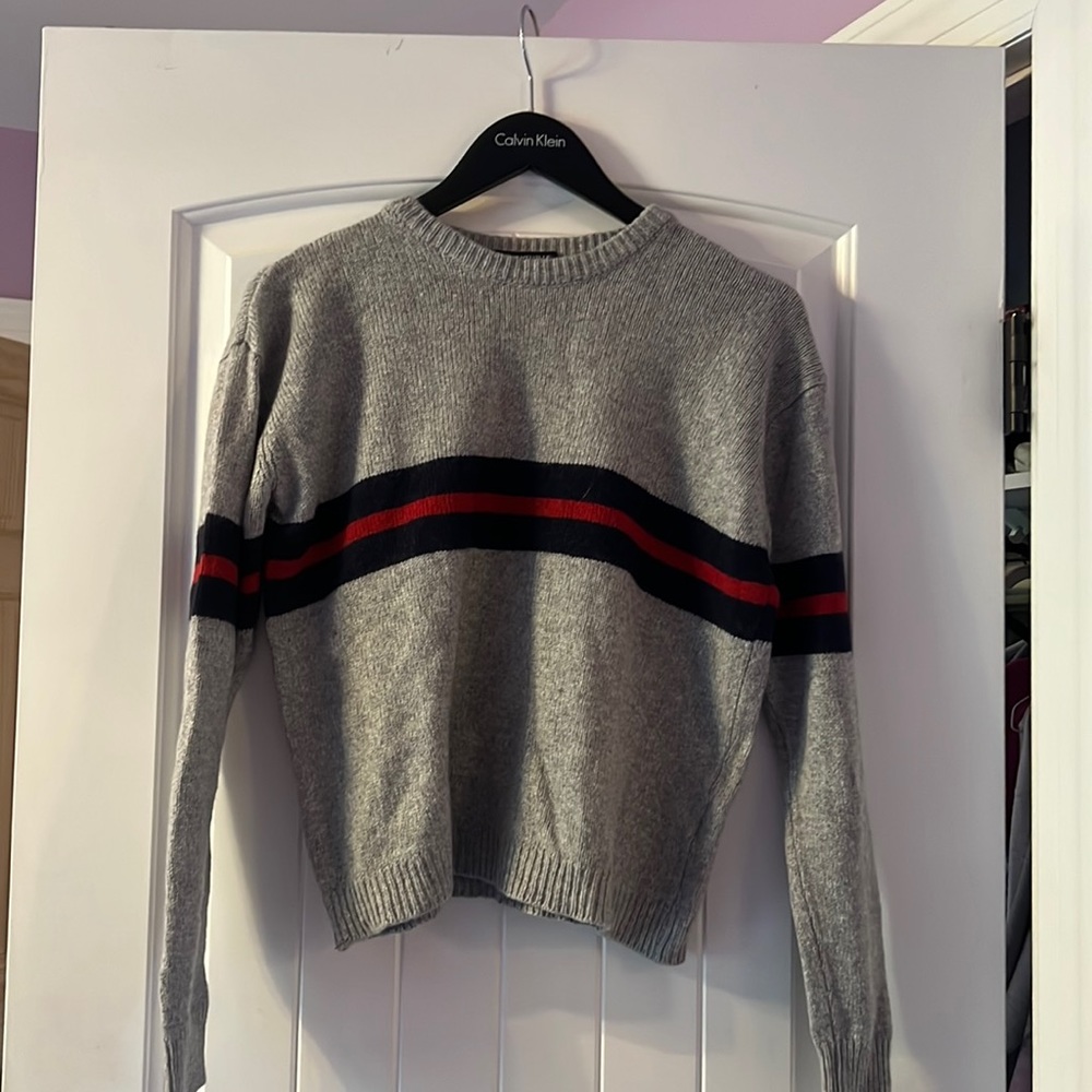 A brandy Melville sweater with blue and red stripes